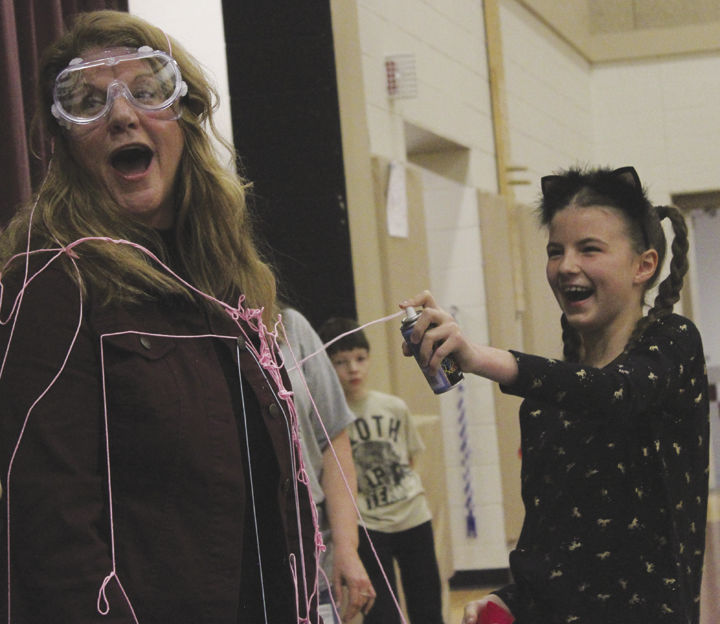 Kayla Halfast, right, shoots Silly String at Gail Swank,
